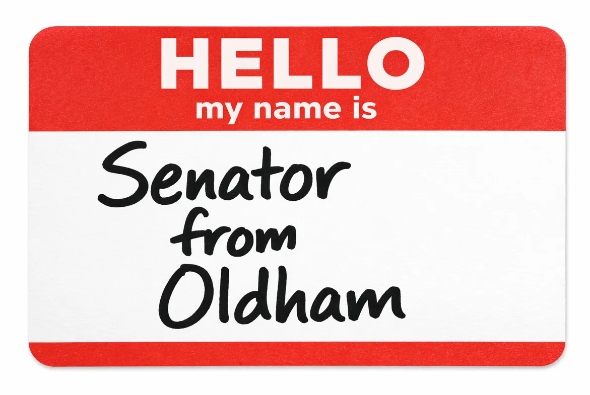 Name tag that says “Senator from Oldham”
